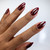 Hand with The GelBottle Inc gel nail polish on the nails in the shade, Velvet Red.