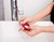 ISOCLEAN cosmetic sponge cleaner 525ml being used to clean a pink sponge under a tap.
