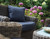 Mayfair 2 seater sofa in the shade olive with cushions in a garden.