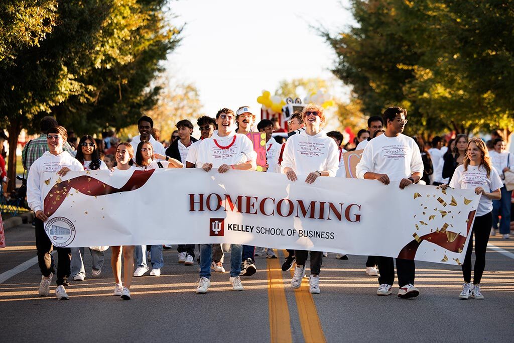 Crowd of Kelley students carrying a banner for Homecoming