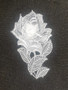 large embroidered white rose motif