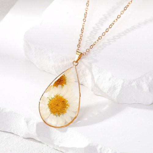 white flower with yellow centre pressed inside resin teardrop shape pendant necklace