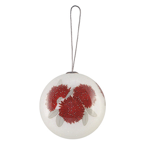 White Christmas bauble with crimson pōhutukawa flowers