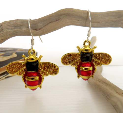 Bright little Bee earrings hung from hooks
