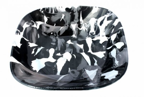 Glass bowl with black and white cow design with words New Zealand