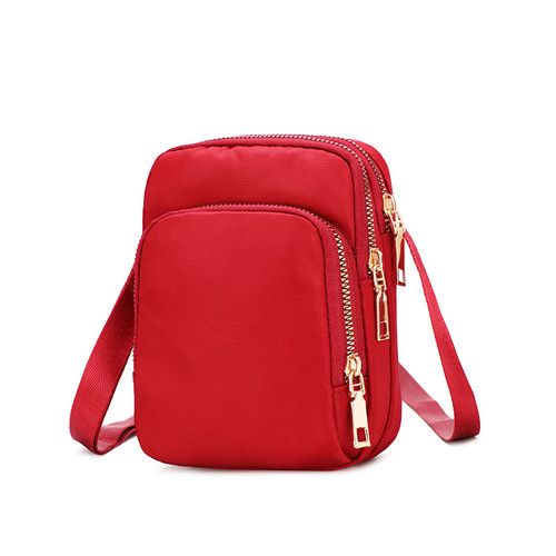Small crossbody bag with three pockets with zips - red