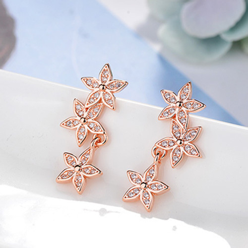 Rose gold coloured 3 flower earrings with diamantes on posts