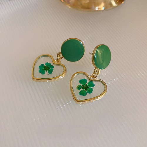Resin heart with green flower on circle studs