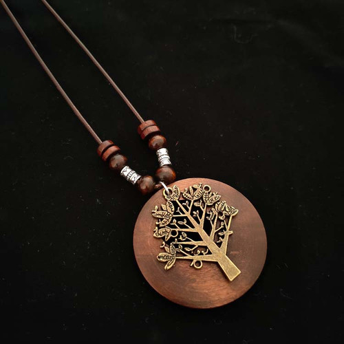 Wooden pendant with antique look tree on brown cord