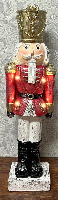 Nutcracker soldier in red uniform and gold hat with LED lights