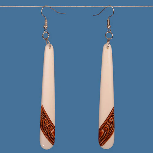Long bone earrings with brown dyed koru design