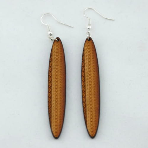 Long wooden oval earrings with tattoo design on hooks