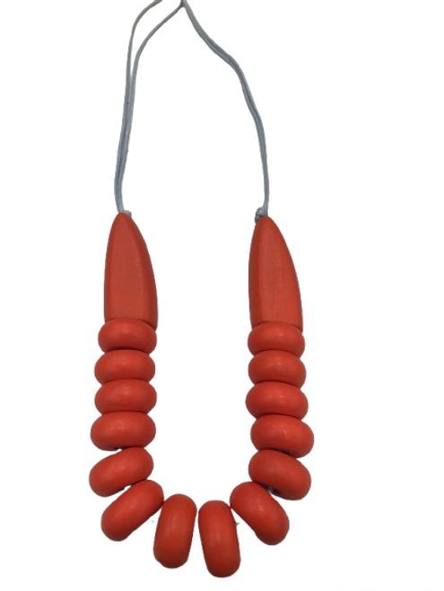 Bright orange wooden bead necklace on cord Bright orange wooden bead necklace on cord