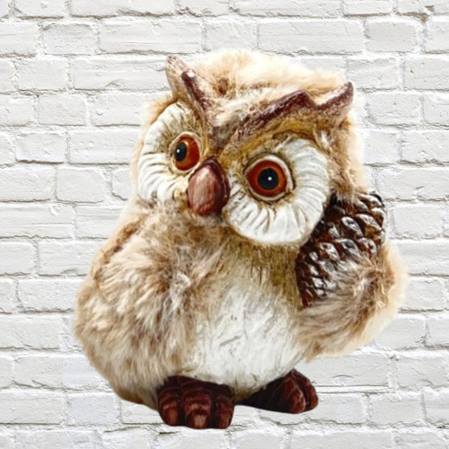 ornamental Owl with faux fur feathers holding an acorn