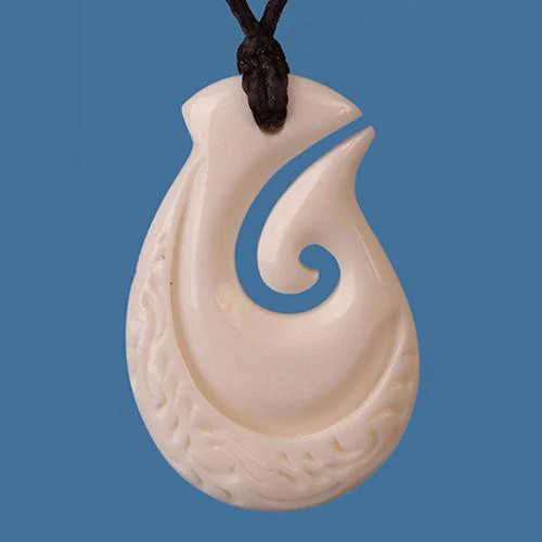 Bone fish hook pendant with carved koru design