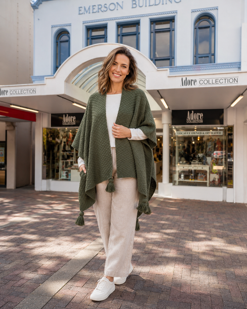 Women's warm textured knit cape with tassels olive, in front of Adore Collection, Napier