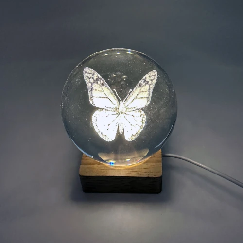 Butterfly etched crystal ball night light glowing