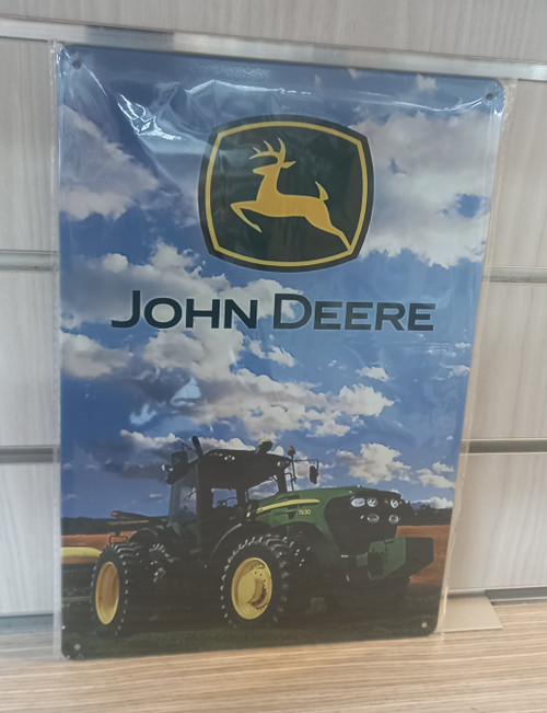 John Deere tractor in field tin sign