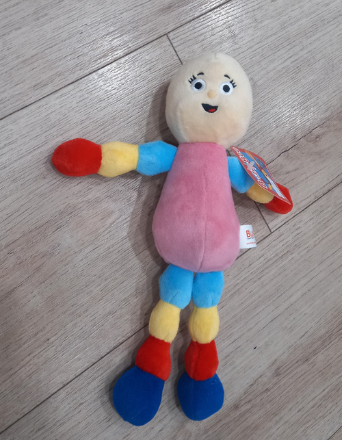 Mary Lou soft toy with smiling cream face, pink dress and colourful blue, yellow and red limbs