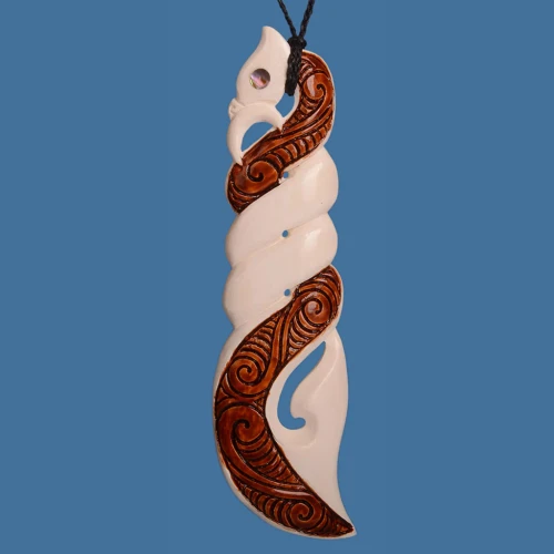 Long bone pikorua twist manaia pendant with brown carved detailing, pāua shell eye and black cord