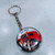 Art Deco man  in front of red car on round double sided key ring
