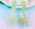 Cute Dinosaur skeleton on Arylic hung from Pale blue stud on posts