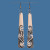 Long Bone earrings with Koru pattern hung from hook
