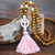 Long wood bead boho style pendant necklace with pastel pink tassel and white peace sign shape