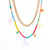 Double layer necklace with Colourful multi dinosaur and fruit charms on beaded necklace with another layer of gold link chain making up the look