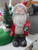 25cm tall Santa figurine holding a small Christmas Tree