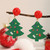 Sparkly Christmas Tree hanging from under red stud earring on posts