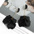 long earrings with black petals hung from gold coloured rod beneath an acrylic stud on s925 posts