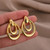 Double loop gold earrings on stud