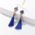 Tassel earring with gold coloured crown hanging from coloured stone on gold coloured hooks - sapphire blue