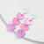 drop of two pink hearts and one glittery heart earrings on hook