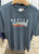 Denim blue colour Napier NZ souvenir T-shirt with red, blue, yellow and white wave design - Size L