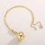 Stainless steel ball necklace on gold coloured chain
