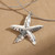 Silver coloured solid starfish pendant on choker