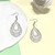 Small white wooden cut out teardrop earrings on hooks