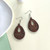 Small dark brown wooden cut out teardrop earrings on hooks