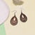 Small deep red wooden cut out teardrop earrings on hooks