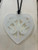 Acrylic heart necklace with cut-out kōwhaiwhai design