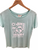Mint coloured women's Napier NZ souvenir T-shirt with white dolphin and the words "sun, sea, dream"
