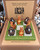 Kiwi vs Kangaroo tic tac toe game with animal playing pieces on a green board in its display box