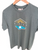 Moss-green Napier New Zealand souvenir T-shirt with sunrise and blue wave design