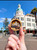 Hand holding the Napier bamboo vintage car magnet in front of an Art Deco building