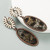 long oval earrings with white stone stud and animal print features