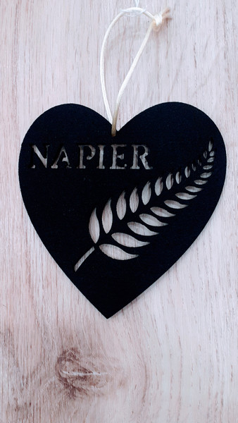 Napier with a fern leaf cut out of hanging black felt heart