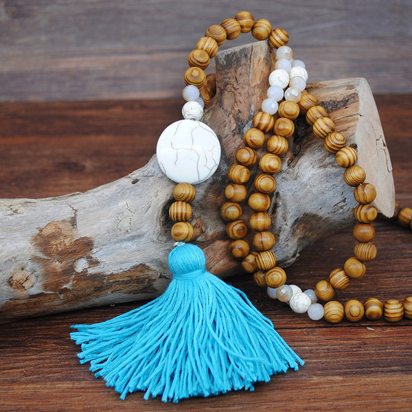 Long wood bead boho style pendant necklace with turquoise blue tassel and white round shape