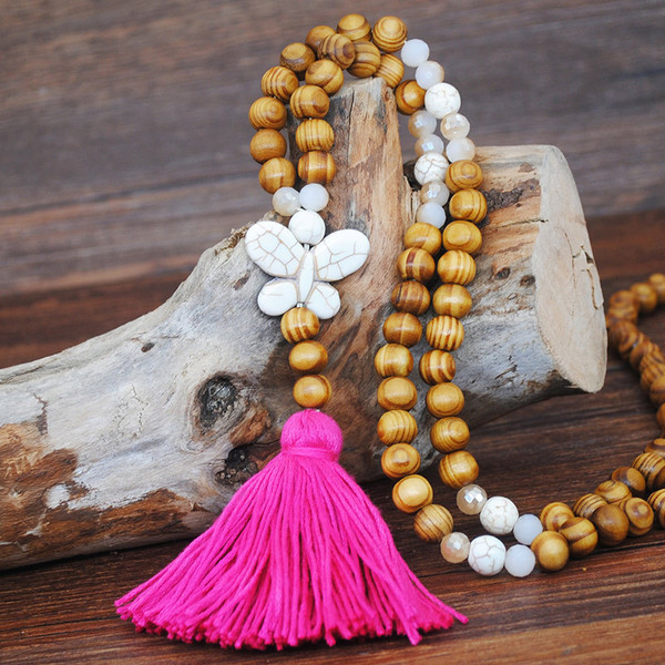 Long wood bead boho style pendant necklace with bright pink tassel and white butterfly shape